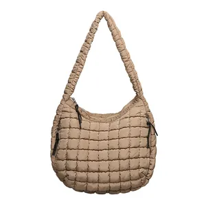 Casual quilted nylon shoulder bag in khaki with a padded puffy texture and hobo style.