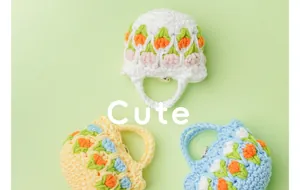 Detailed macro view showing three colorful handmade crochet tulip pattern earphone pouches