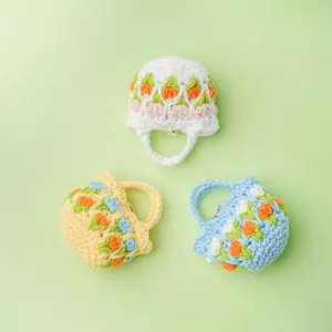 Handmade crochet tulip mini pouches for wireless earphones in white, yellow, and blue colors