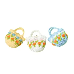 Handmade crochet tulip earphone case cover in yellow, white, and blue pastel colors