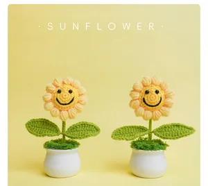 Close-up showing the intricate texture of two handmade crochet sunflowers with smiley faces