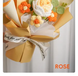Detailed view of hand-knitted rose bouquet with yellow wrapping and ribbon