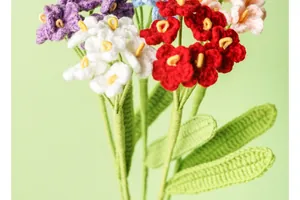 Close-up detail of handmade colorful crochet forget-me-not flowers with soft yarn texture.