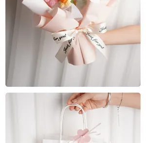 Detailed view of a handmade knitted flower bouquet with a ribbon and white gift paper bag.