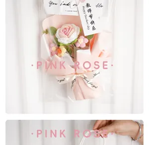 Handmade knitted pink rose bouquet in elegant gift packaging with decorative ribbon