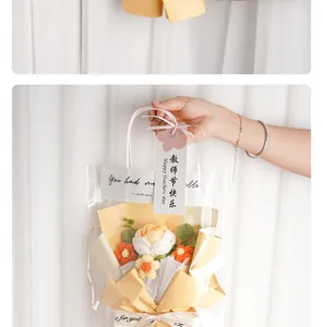 Detailed view of hand-knitted crochet flower bouquet inside a clear gift bag with handle