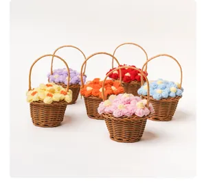 Collection of six mini handmade woven baskets filled with colorful crochet puff flowers.