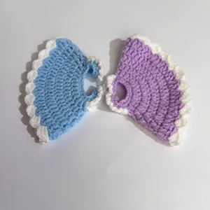 Detail of hand-crocheted princess dresses for 20cm plush dolls in blue and purple