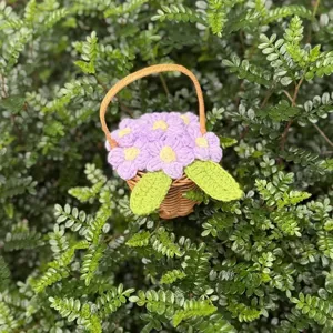 Handmade mini crochet puff flower basket ornament featuring purple flowers for desktop decoration