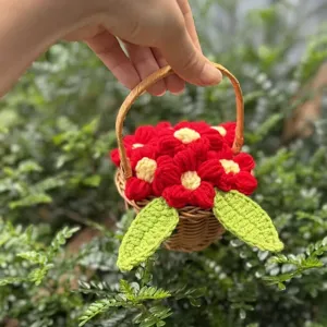 Handmade mini crochet flower basket with red puff flowers and green leaves for decor