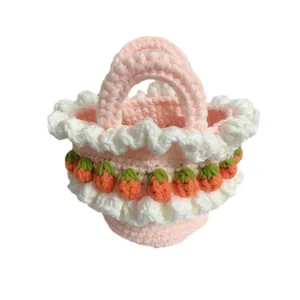 Detailed view of handmade crochet pink basket with white ruffles and strawberries