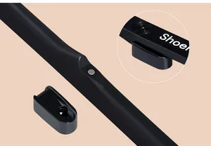 Detailed macro view showing the magnetic wall mount of a long black shoehorn