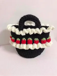 Close-up of handmade crochet tote bag with strawberry design