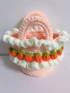 Close-up of a handmade crochet strawberry picnic basket bag with a cream ruffled trim