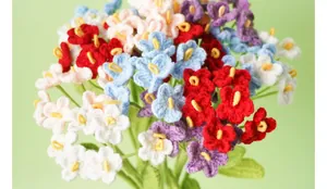 Close-up view of vibrant handmade crochet forget-me-not flowers in multi-color yarn