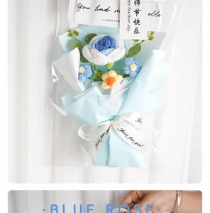 Close-up of hand-knitted blue rose crochet bouquet with gift packaging and card
