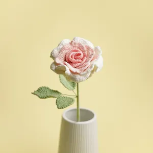 Handcrafted pink and white crochet Thai rose flower in a minimalist white ceramic vase