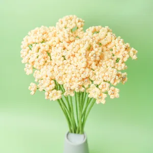 Handmade crocheted baby's breath flower bouquet with tiny pearls in a ceramic vase