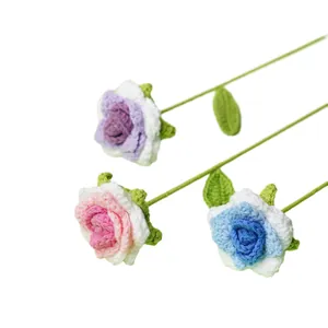 Hermosas rosas de ganchillo hechas a mano en púrpura, rosa y azul sobre fondo blanco.