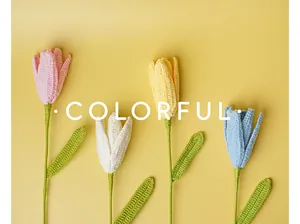 Detailed view of four colorful handmade crochet tulips in pink, white, yellow, and blue colors.