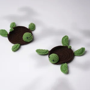 Handmade crochet turtle coasters set featuring two knitted wool tabletop protectors in green and brown
