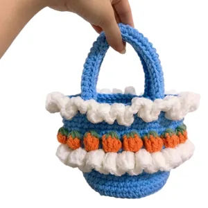 Handmade knitted blue handbag with strawberry lace details