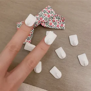 Set of mini white adhesive wall hooks for hanging jewelry and keys, compact size hangers