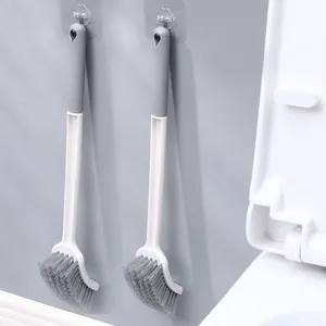 Wall-mounted toilet brush with long handle and curved bristles for deep cleaning