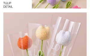 Close-up of handmade crochet tulip flowers in decorative LOVE printed gift bags