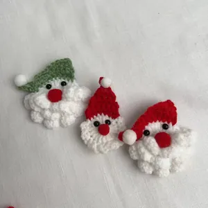 Adorable handmade crochet Santa Claus brooch and hair clip for Christmas creative gifting.
