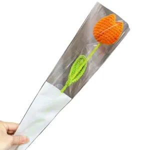 Beautiful handmade orange crochet tulip flower presented in transparent gift wrapping