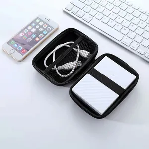 Black 2.5 inch hard drive case organizer opened on white desk next to a keyboard