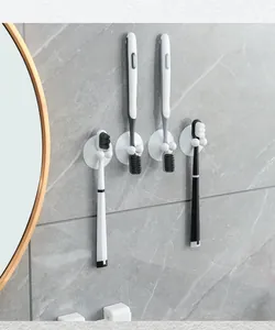Detail view of white suction cup toothbrush holders mounted on a gray marble bathroom wall