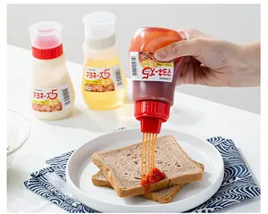 Detail showing 5-hole nozzle squeezing red sauce onto toast for breakfast