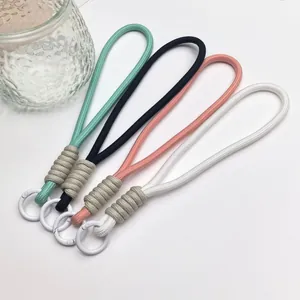 Four hand-woven phone lanyards in pastel colors with circular clips on white background.