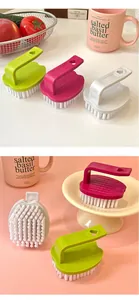 Close-up of candy colored egg-shaped laundry brushes with heart-shaped handles and white bristles