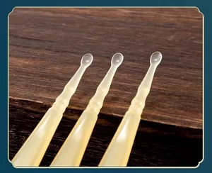 Close-up of three translucent soft resin ear picks for professional gentle ear cleaning