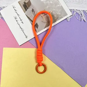 Detailweergave van een feloranje gevlochten paracord polsbandje met een metalen ring