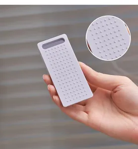 Close-up detail of purple silicone door stopper with non-slip dotted texture for safety