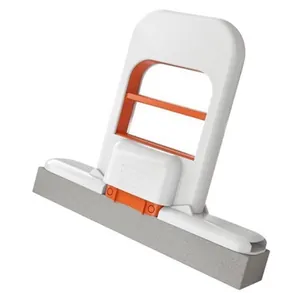 Close-up of a mini handheld sponge mop with white and orange frame for desktop cleaning
