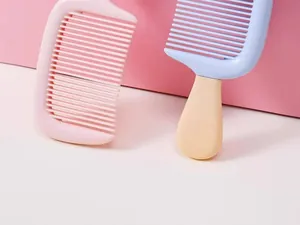 Detail view of cute ice cream shaped hair combs in pastel pink and blue colors