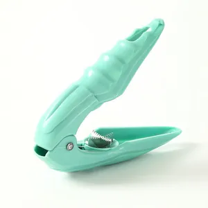 Ergonomic mint green chestnut opener and nutcracker tool for effortless shelling.