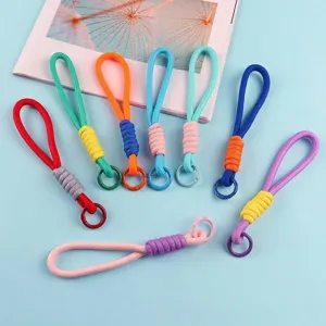 Detailed view of colorful braided wrist lanyards with detachable rings for phones