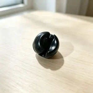 Detailed macro view of black spherical slot component for suction cup toothbrush holder