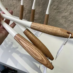 Detail view of Japanese style long-handled toilet brushes with natural wood handles.