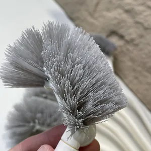 Close-up detail of dense grey bristles on a Japanese style toilet cleaning brush