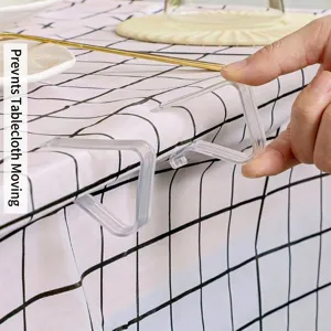Transparente Tischdeckenklammern aus Kunststoff halten die Decke fest.