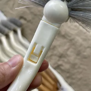 Detailed close-up view of the plastic handle mechanism on a toilet cleaning brush
