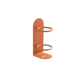 Wandmontierter orangefarbener Zahnbürstenhalter aus Eisen für die minimalistische Badablage.