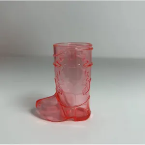 Detailed close-up view of a pink translucent cowboy boot shaped plastic shot glass
